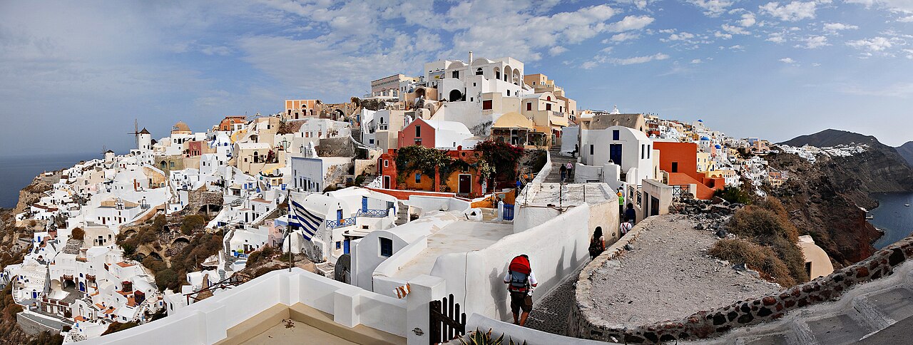 Orange clay roof tiles on white buildings in Santorini, Greece