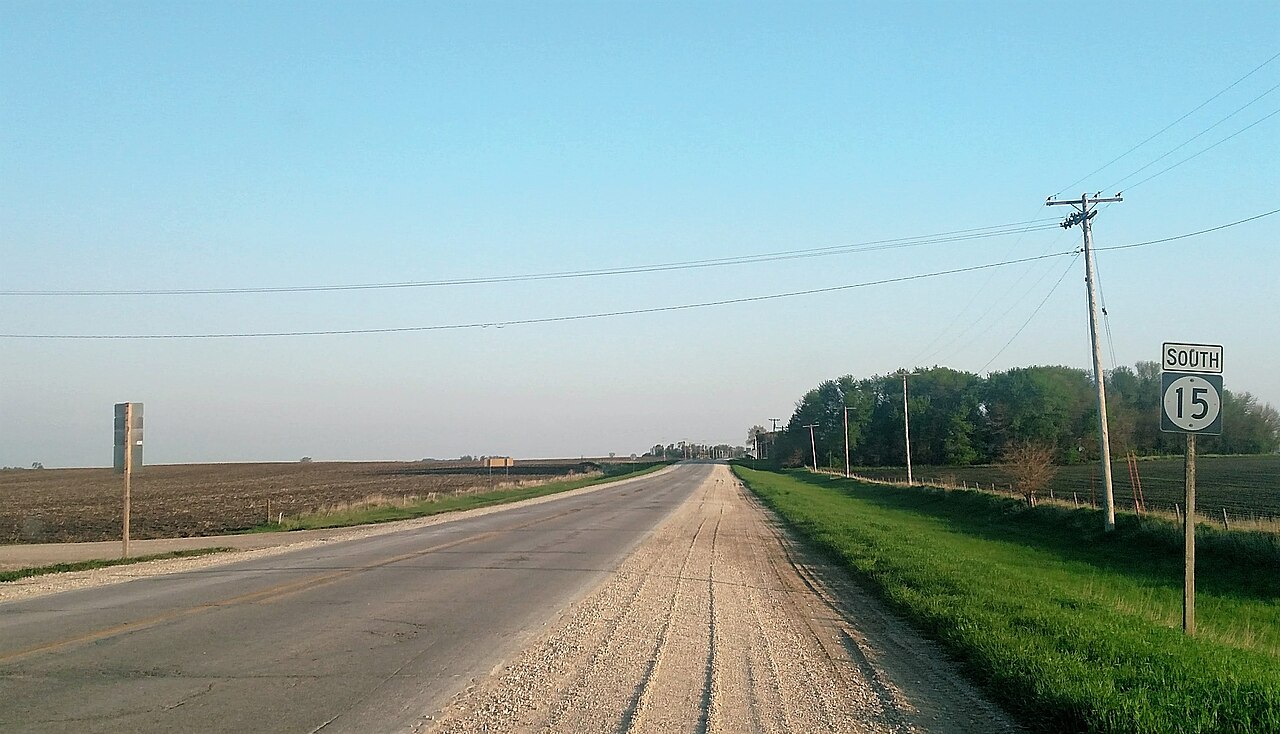 Wooden utility poles along a rural Iowa road — pole type and density are regional GeoGuessr meta